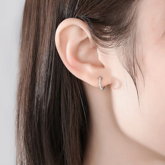 925 sterling silver clip-on earring with zircon rhinestones shown worn on a woman’s ear, no piercing required.