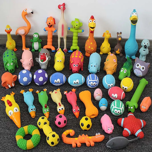 Large assortment of colorful squeaky dog toys in animal shapes, balls, bones, and chew rings, displayed on a carpeted floor