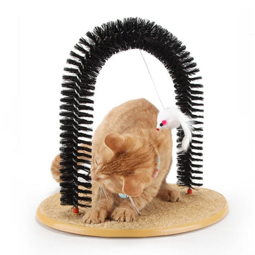 Orange tabby cat using a self-grooming arch toy with black bristles, a sisal scratching mat base, and a hanging white plush mouse.