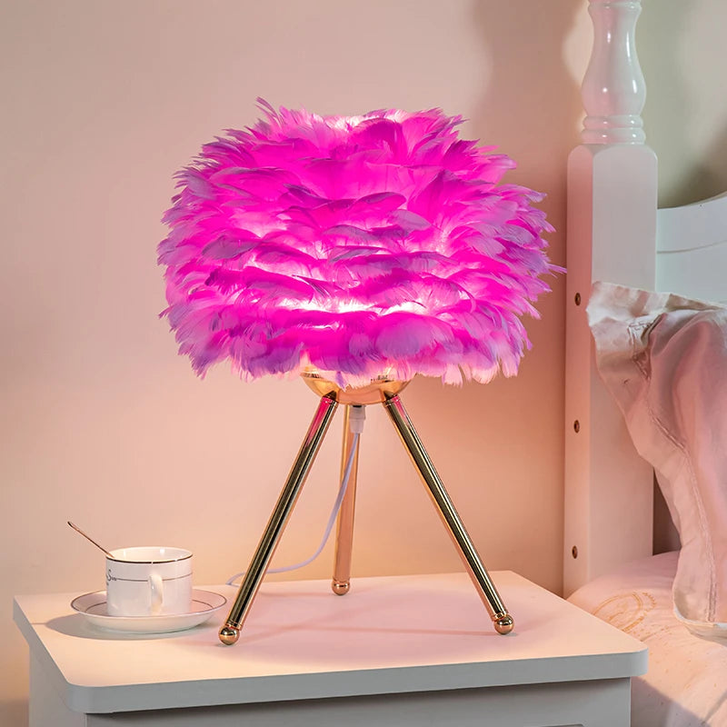 Romantic pink Nordic feather lamp with soft LED glow on bedside table