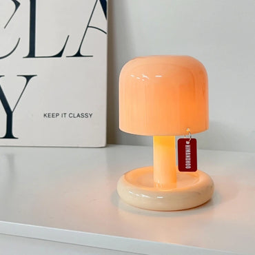 Mini sunset mushroom night light glowing on white shelf next to decorative book, perfect for modern room decor