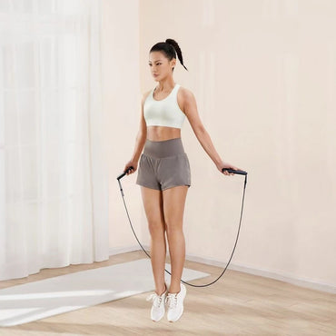 Woman using Xiaomi Mijia jump rope in indoor mode for fitness tracking
