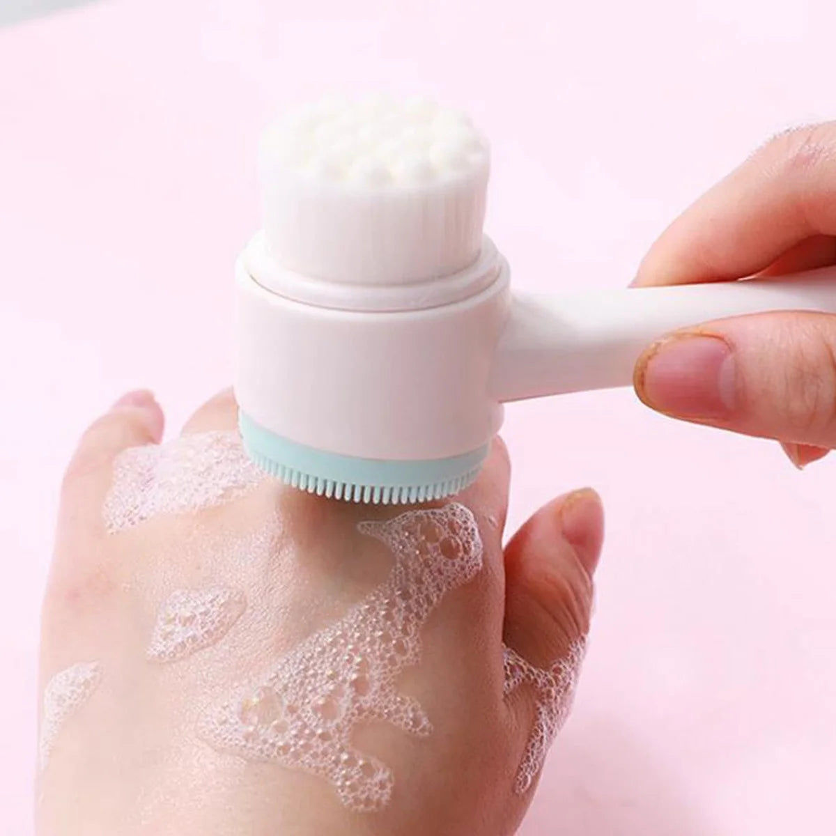 Double-sided silicone face brush with soft bristles being used to lather and cleanse hand skin – gentle exfoliating tool for skincare routine by BeTrendy