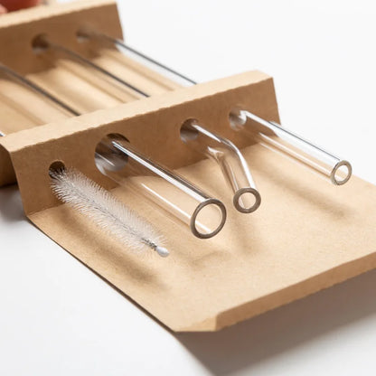 Close-up of eco-friendly glass straw set with cleaning brush in cardboard holder – reusable drinking straws by BeTrendy