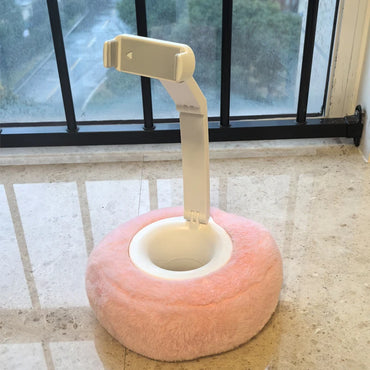 Adjustable phone stand with plush pink donut-shaped base on windowsill – cute and stable hands-free holder by BeTrendy