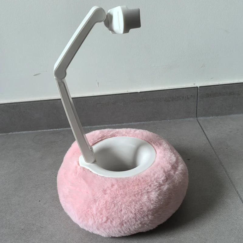 Adjustable arm phone stand with plush pink cushion base on tiled floor – stable and cozy phone holder by BeTrendy