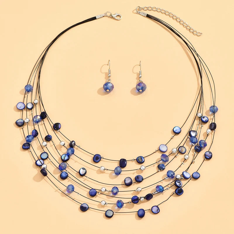 Elegant dark blue shell necklace and matching earrings in a layered boho design. Boho.  BeTrendy