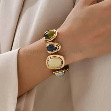 Bohemian colorful rhinestone vintage bracelet worn on wrist, featuring multicolor geometric stones in gold-tone settings