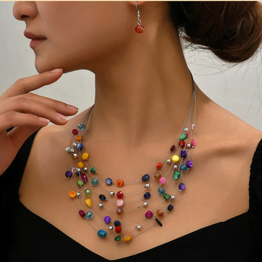 Woman wearing a multicolor bohemian shell necklace and matching drop earrings .  BeTrenndy