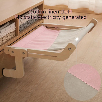 Close-up of pink canvas hammock fabric with wooden frame, showing anti-static cotton linen material.