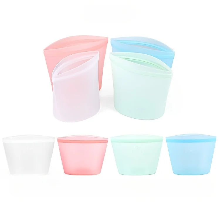 Set of colorful reusable silicone food storage bags in pink, white, green, and blue—ideal for organizing snacks, meals, and freezer storage
