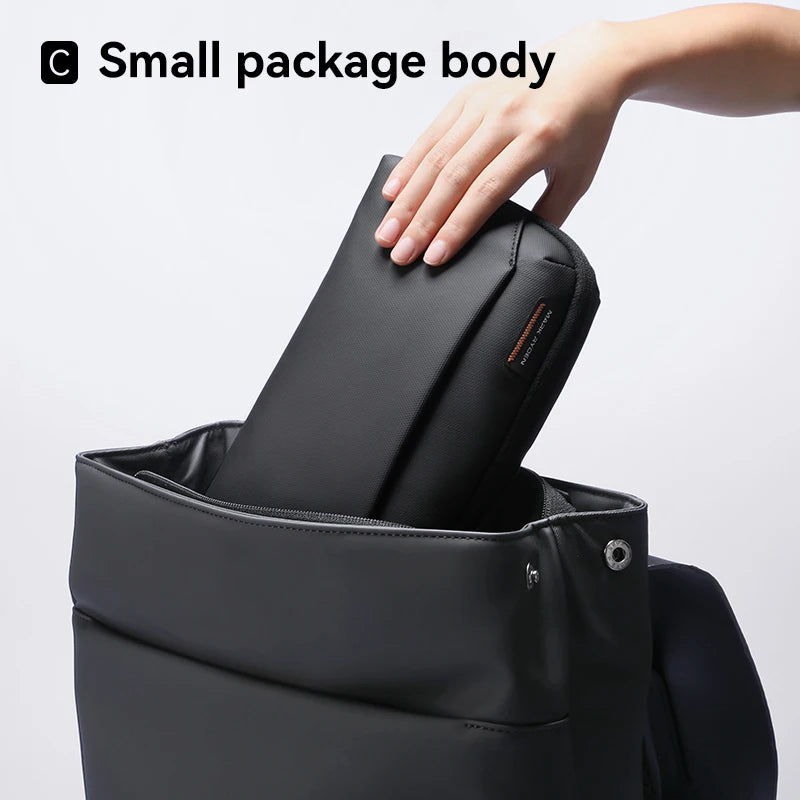 Hand placing a compact Mark Ryden tech organizer pouch into a backpack – slim design ideal for travel and everyday carry. BeTrendy
