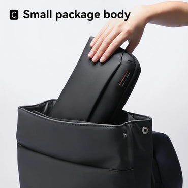 Hand placing a compact Mark Ryden tech organizer pouch into a backpack – slim design ideal for travel and everyday carry. BeTrendy