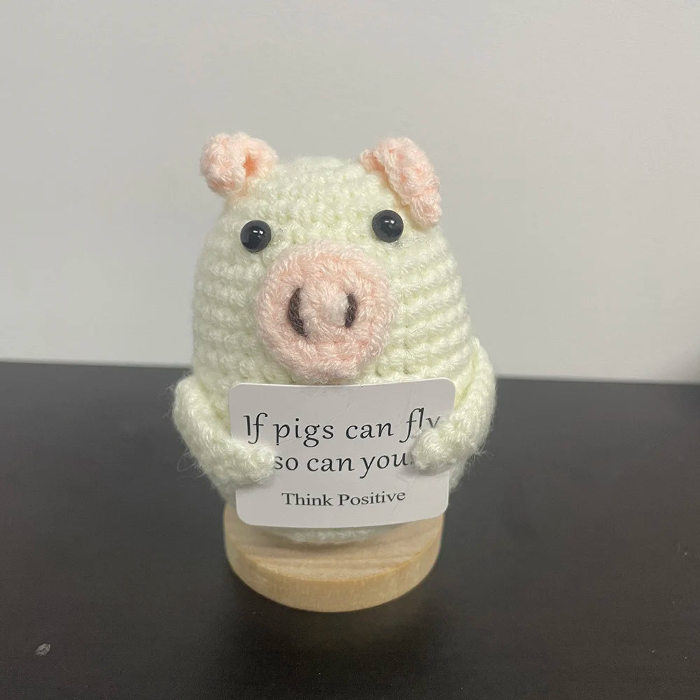Handmade crochet pig doll holding a sign that says "If pigs can fly, so can you – Think Positive BeTrendy