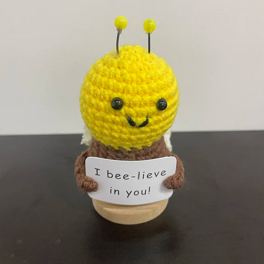 Handmade crochet bee doll with a sign that says 'I bee-lieve in you' — cute motivational gift or desk decor