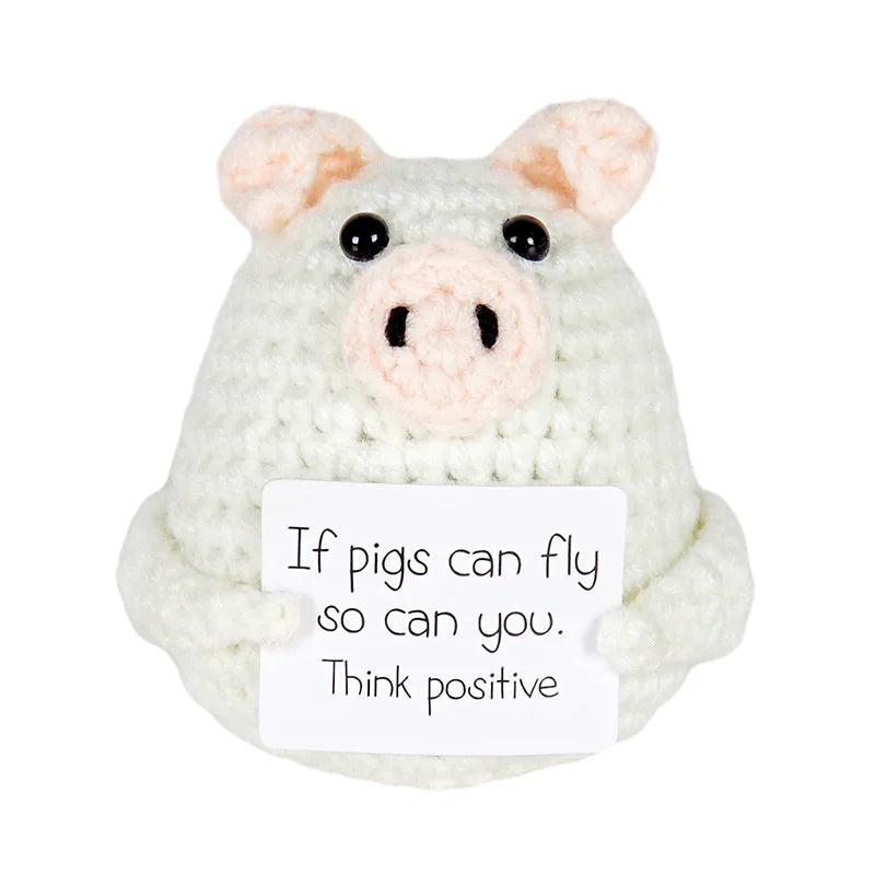 Handmade crochet pig doll holding a sign that says 'If pigs can fly so can you. Think positive' — cute motivational gift or decor piece
