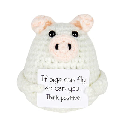 Handmade crochet pig doll holding a sign that says 'If pigs can fly so can you. Think positive' — cute motivational gift or decor piece
