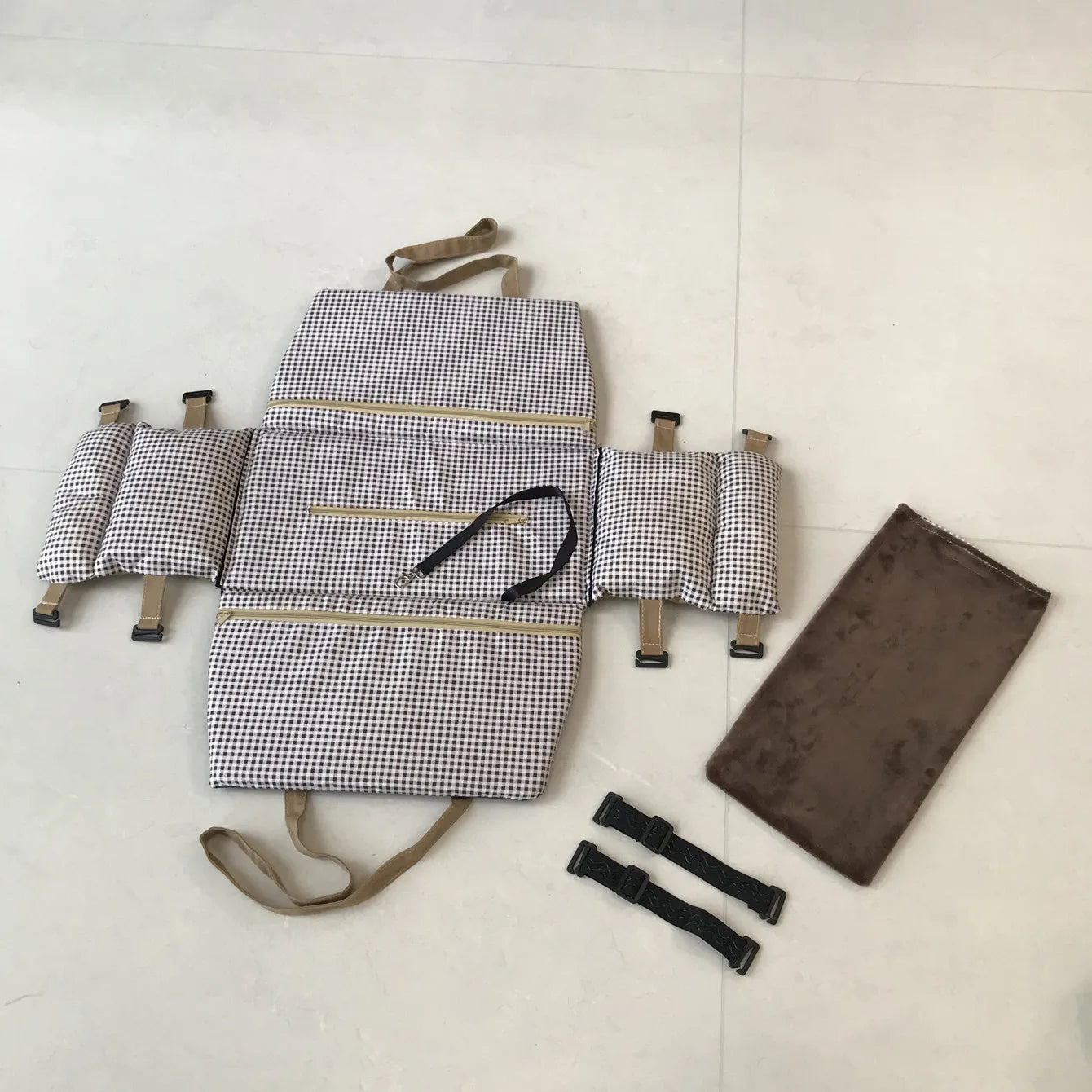 Fully disassembled view of the portable dog car seat showing straps, padding, and fabric pieces for easy setup and cleaning.