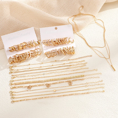 Flat lay of 37-piece gold boho jewelry set with layered necklaces, bracelets, and geometric hoop earrings  Boho BeTrendy