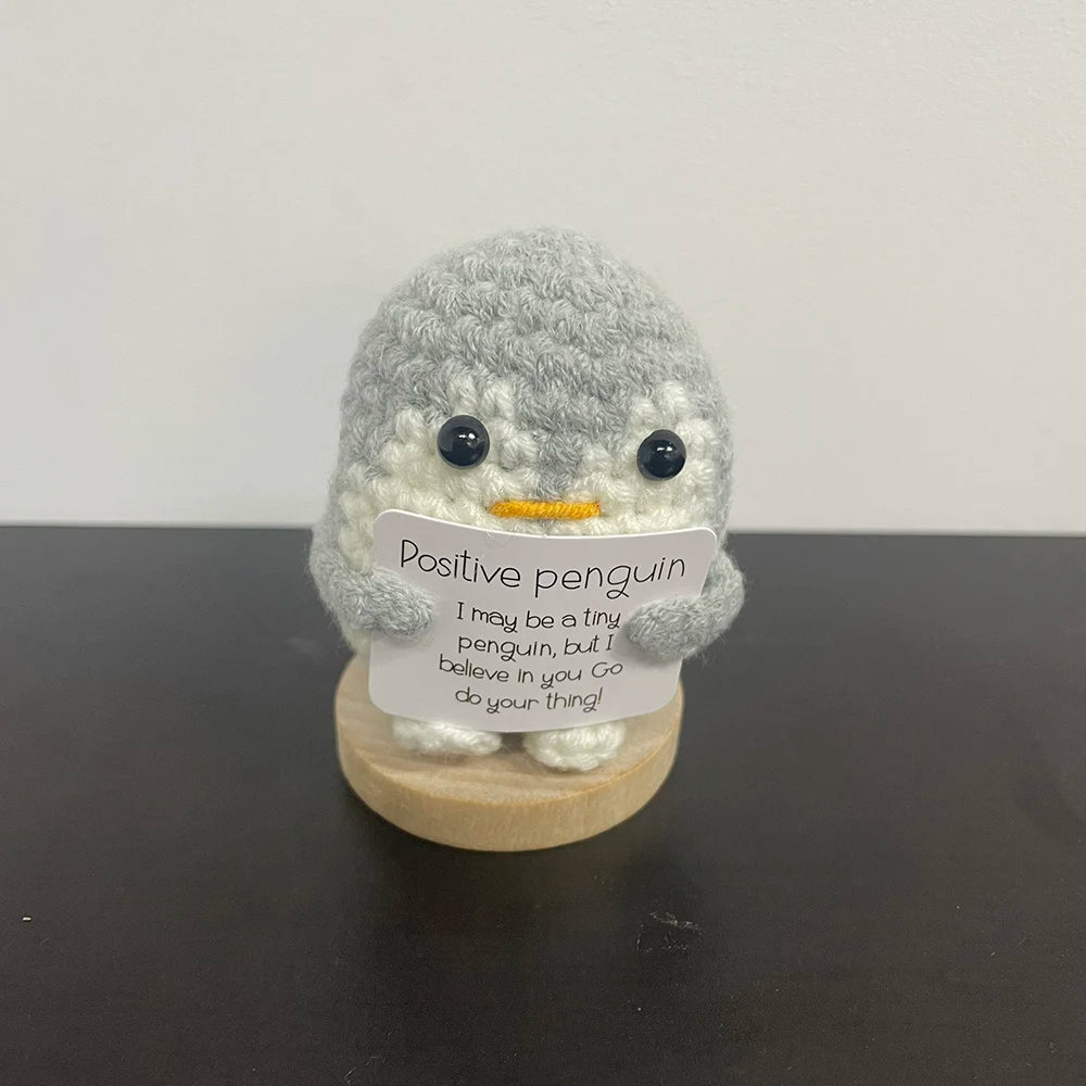 🐧🧶 Gray crochet penguin holding a sign: "I believe in you! 💙💫 Go do your thing!