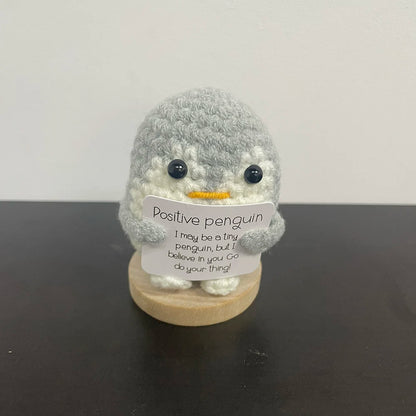 🐧🧶 Gray crochet penguin holding a sign: "I believe in you! 💙💫 Go do your thing!