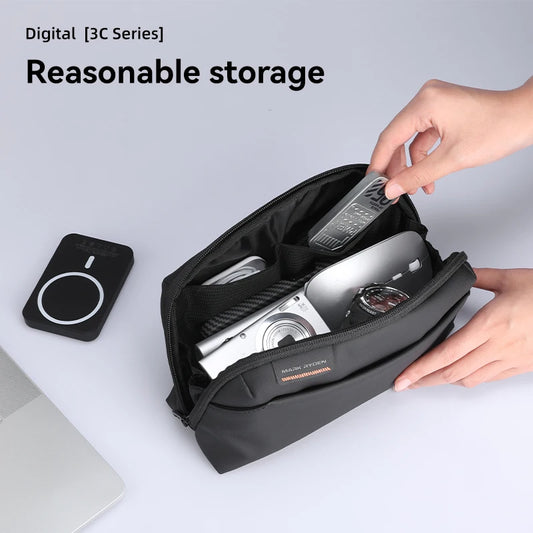 Hands organizing tech accessories in Mark Ryden compact storage pouch – neatly holds camera, power bank, remote, and watch.  BeTrendy