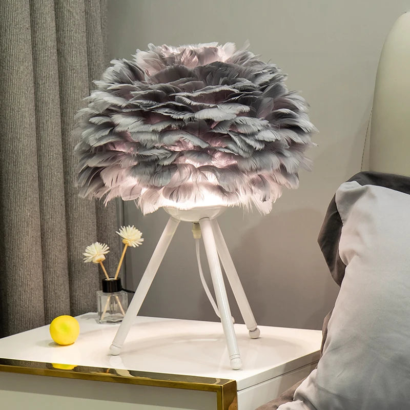 Modern Nordic gray feather table lamp with warm LED light on white dresser