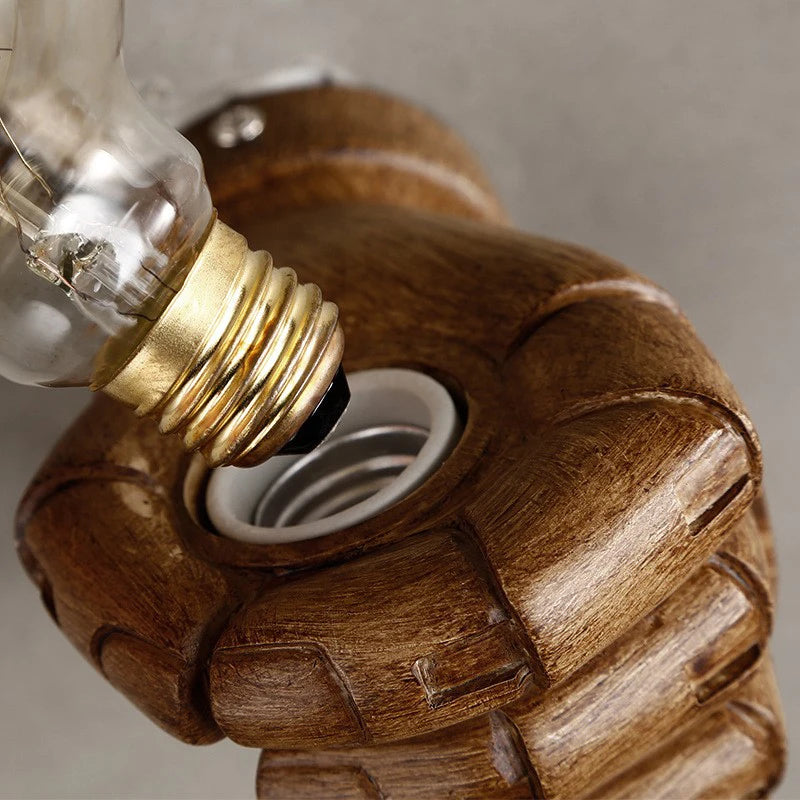 Close-up of E27 bulb being screwed into a Nordic resin hand wall lamp socket, highlighting wood-like texture and easy installation