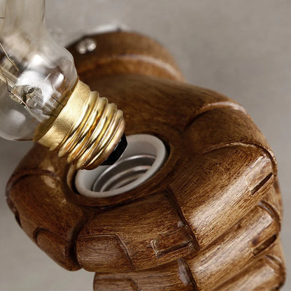 Close-up of E27 bulb being screwed into a Nordic resin hand wall lamp socket, highlighting wood-like texture and easy installation