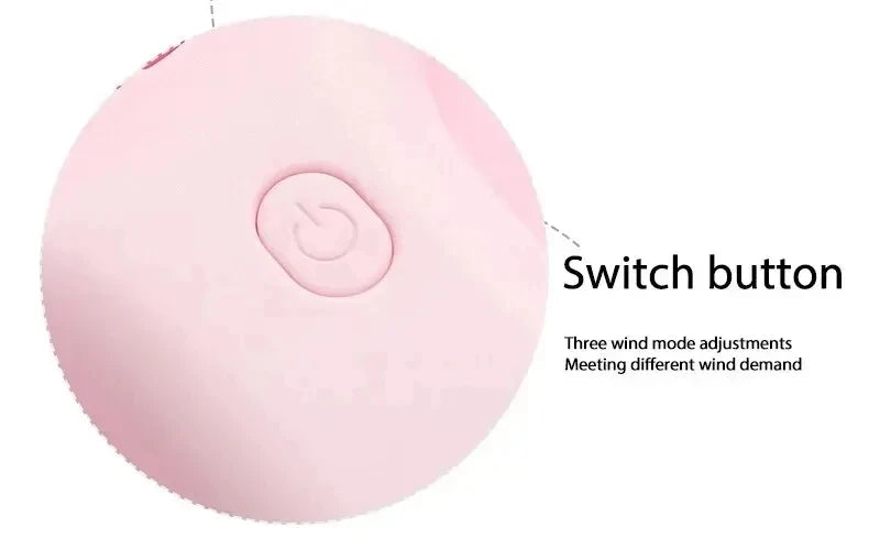Close-up of pink mini fan power button with three adjustable wind speed modes for personalized cooling
