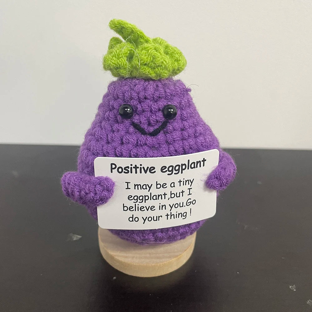 🧶🍆 Cute crochet eggplant holding a sign that says "I believe in you! 💪✨ Go do your thing!