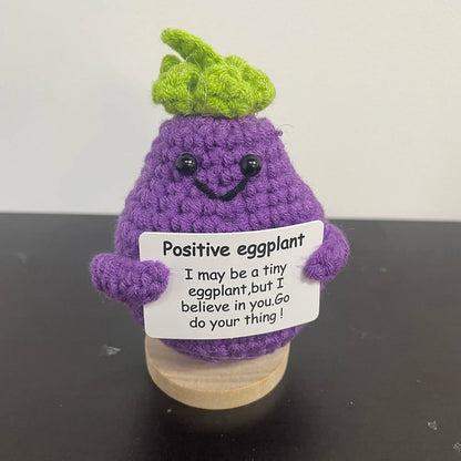 🧶🍆 Cute crochet eggplant holding a sign that says "I believe in you! 💪✨ Go do your thing!
