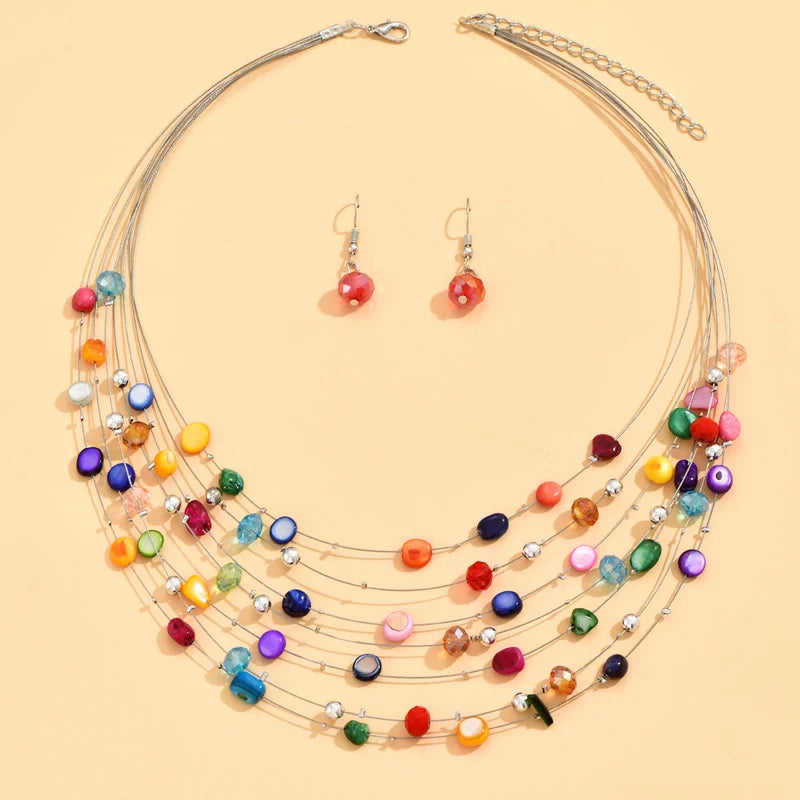 Bohemian style colorful shell necklace with matching earrings displayed flat on beige background.  Boho. BeTrendy