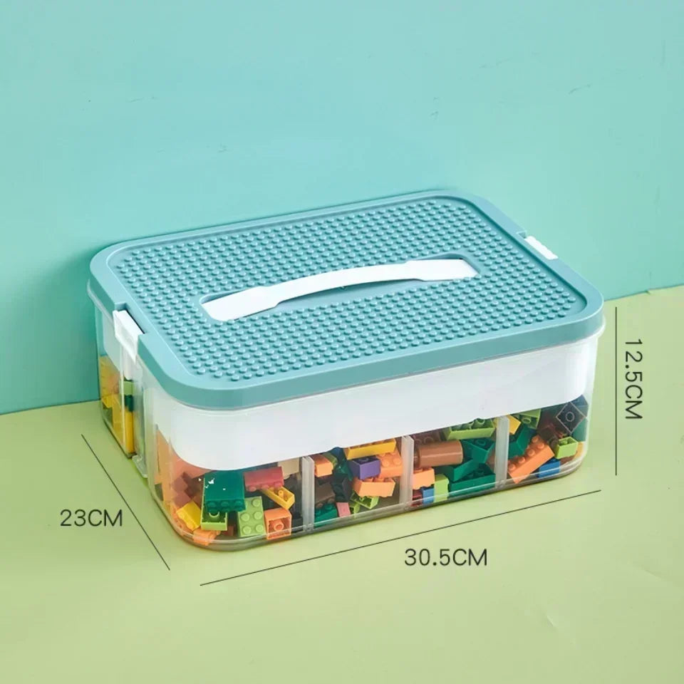 Single-layer Lego-compatible storage box with teal lid and labeled dimensions 30.5 x 23 x 12.5 cm, filled with colorful building blocks