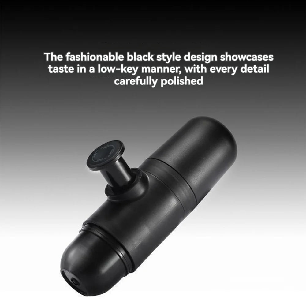 Sleek black portable espresso coffee maker with polished finish, featuring a manual press piston on a gradient black-to-white background