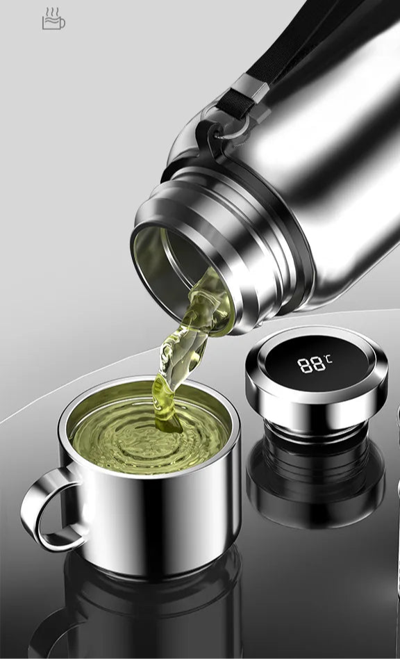Smart thermos bottle pouring hot tea into stainless steel insulated cup with digital temperature display on lid