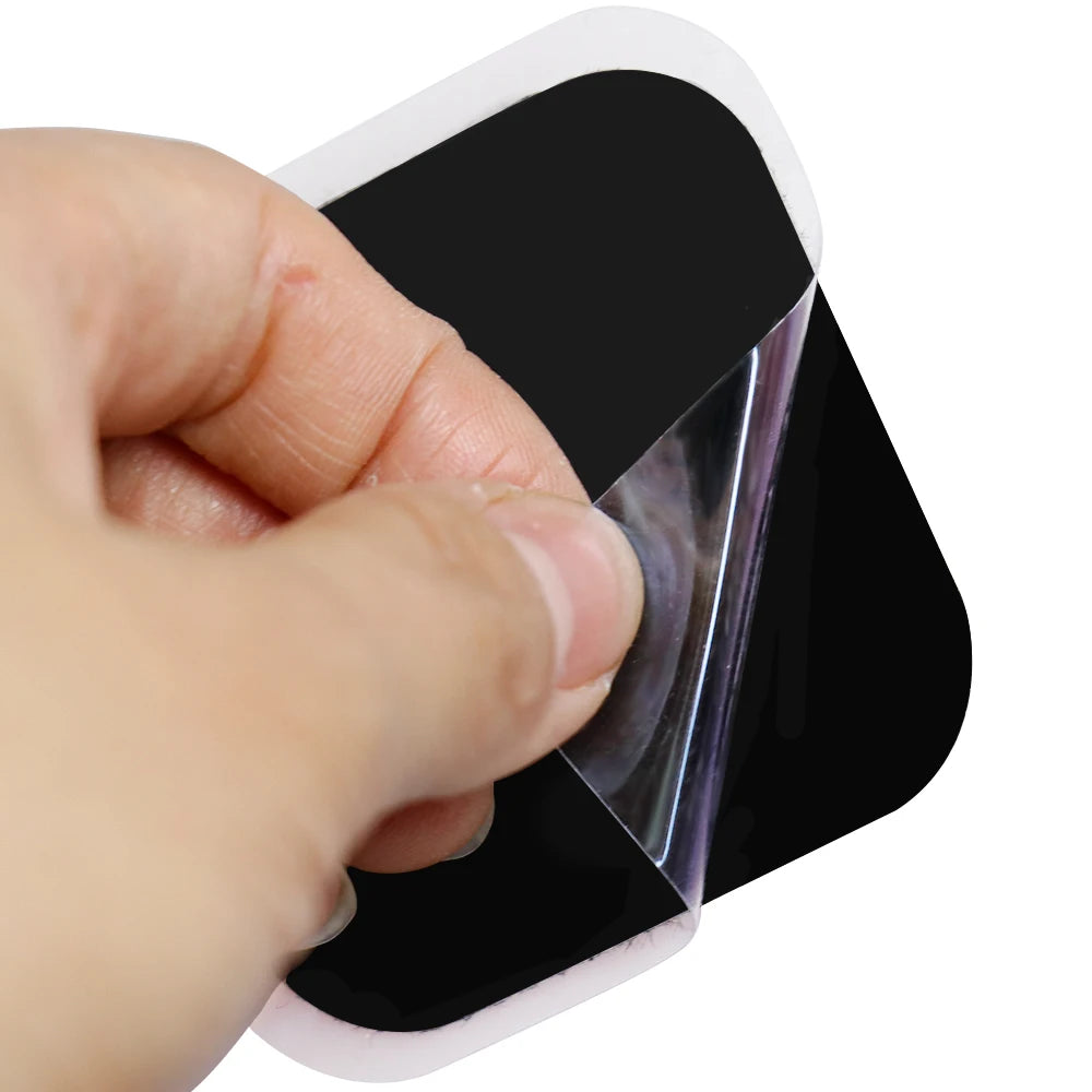 Hand peeling reusable square electrode pad from clear backing sheet