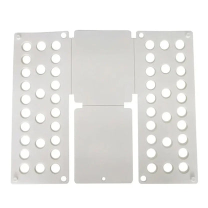 Flat layout of white plastic clothes folding board with ventilation holes for efficient garment folding