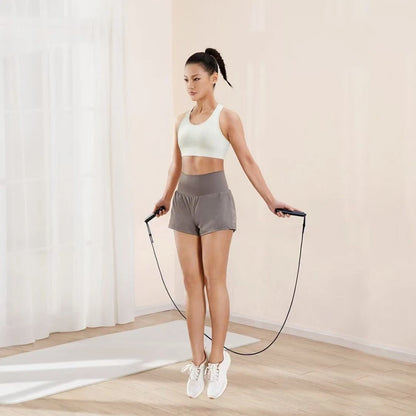 Woman using Xiaomi Mijia jump rope in indoor mode for fitness tracking